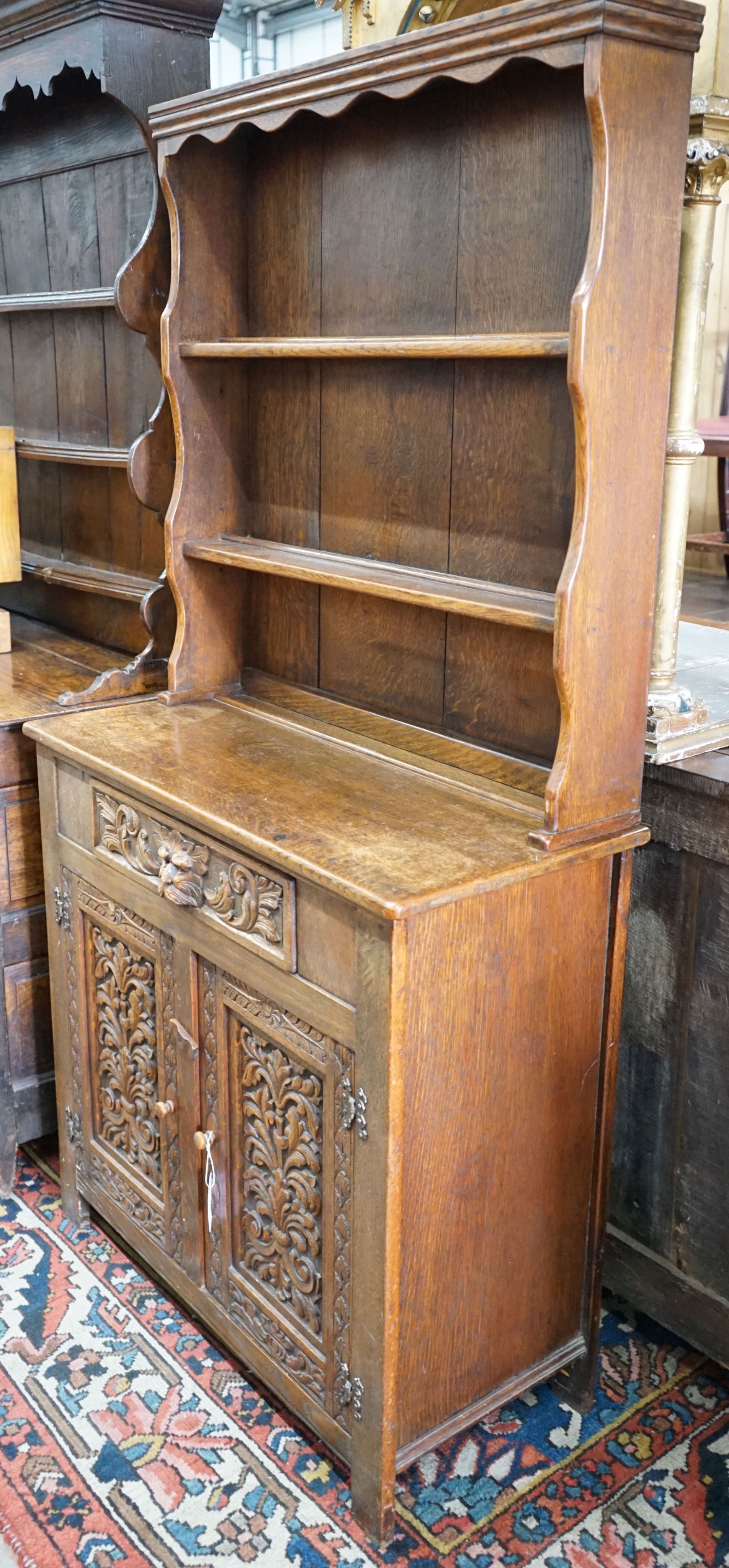 An early 20th century Flemish carved oak dresser, width 91cm, depth 40cm, height 177cm